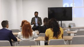 Indian teacher giving a university class in the classroom with students - Powered by Shutterstock - Get 15% off with code: PIKWIZARD15