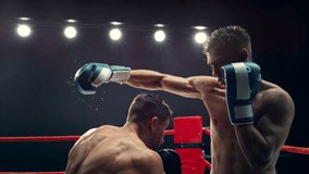 Cinematic Footage with a Speed Ramp Super Slow Motion Effect. Two Professional Boxers Fight in a Ring. Boxer Ducking to Avoiding a Hit, Punching with a Hook to the Face, Rocking the Opponent - Powered by Shutterstock - Get 15% off with code: PIKWIZARD15