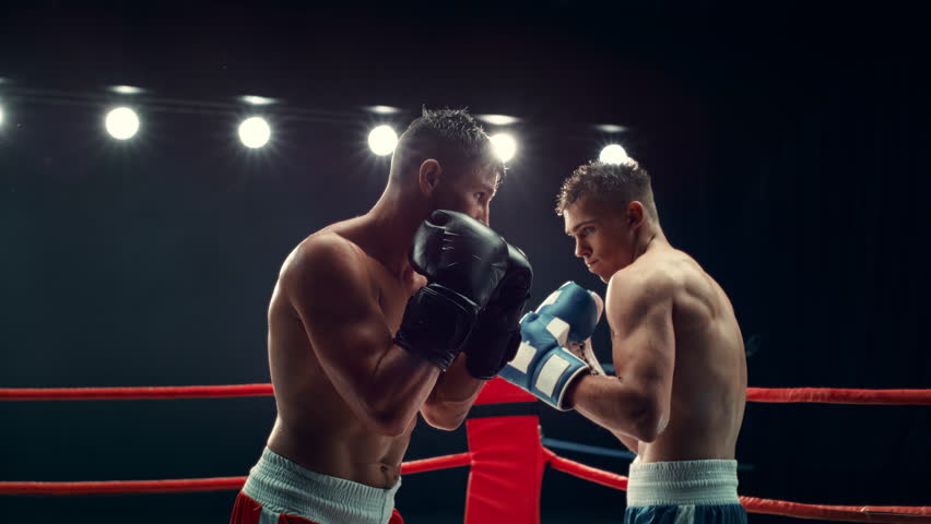 Professional Boxing Match in Super Slow Motion. Boxer Defending From a Punch and Countering with a Hook to the Jaw, Knocking Out the Opponent. Cinematic Footage with a Speed Ramp Action Effect Royalty-Free Stock Footage #1110269877