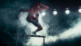 Aesthetic Dark Studio Sports Footage with Super Slow Motion Speed Ramp and Smoke Effects. Talented Male Hurdler Jumping Over Obstacle, Racing Against Time and Setting a New Sprint Record - Powered by Shutterstock - Get 15% off with code: PIKWIZARD15