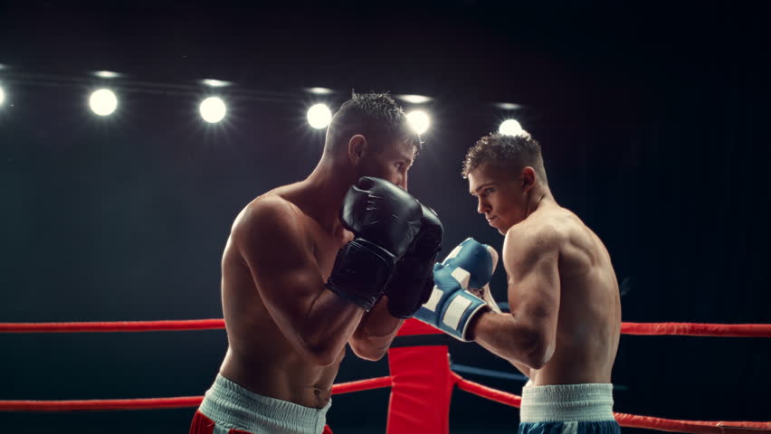 Exciting and Challenging Boxing Match in Super Slow Motion. Boxer Avoiding a Punch and Countering with a Hook to the Jaw, Rocking the Opponent. Cinematic Footage with a Speed Ramp Action Effect Royalty-Free Stock Footage #1110270017