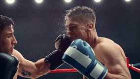 Exciting and Challenging Boxing Match in Super Slow Motion. Boxer Avoiding a Punch and Countering with a Hook to the Jaw, Rocking the Opponent. Cinematic Footage with a Speed Ramp Action Effect - Powered by Shutterstock - Get 15% off with code: PIKWIZARD15