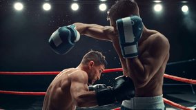 Cinematic Super Slow Motion Sports Footage with Two Professional Boxers Fighting in a Ring. Male Athlete Punching the Opponent in the Body. Sweat Spraying Everywhere From the Heavy Impact - Powered by Shutterstock - Get 15% off with code: PIKWIZARD15
