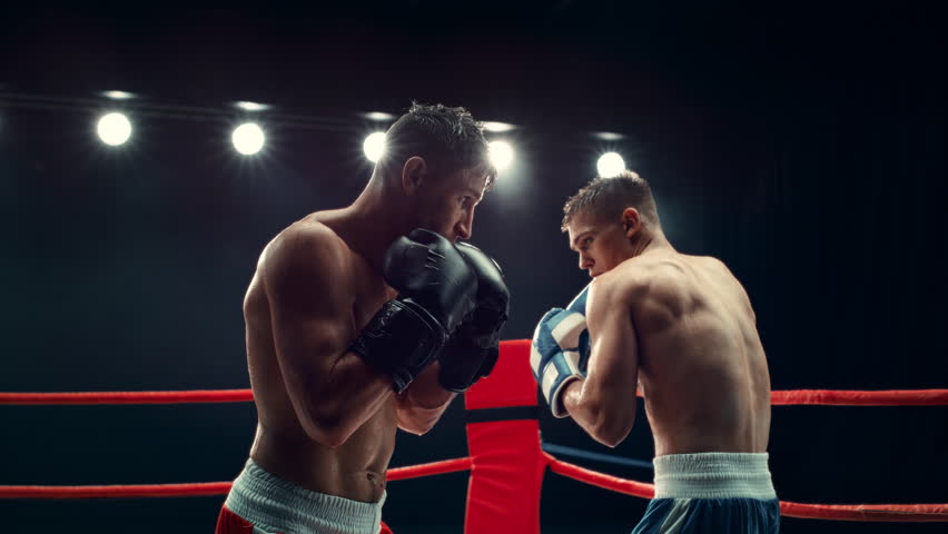 Cinematic Boxing Match in Super Slow Motion. Boxer Avoiding a Punch and Countering with a Hook to the Body, Surprising the Opponent. Aesthetic Footage with a Speed Ramp Action Effect Royalty-Free Stock Footage #1110270025