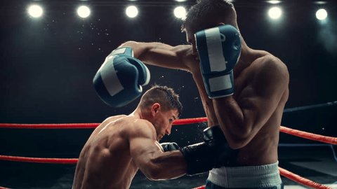 Cinematic Boxing Match in Super Slow Motion. Boxer Avoiding a Punch and Countering with a Hook to the Body, Surprising the Opponent. Aesthetic Footage with a Speed Ramp Action Effect Video Stok