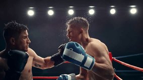 Cinematic Super Slow Motion Sports Footage with Two Professional Boxers Fighting in a Ring. Male Athlete Punching the Opponent in the Face. Sweat Spraying Everywhere From the Heavy Impact - Powered by Shutterstock - Get 15% off with code: PIKWIZARD15