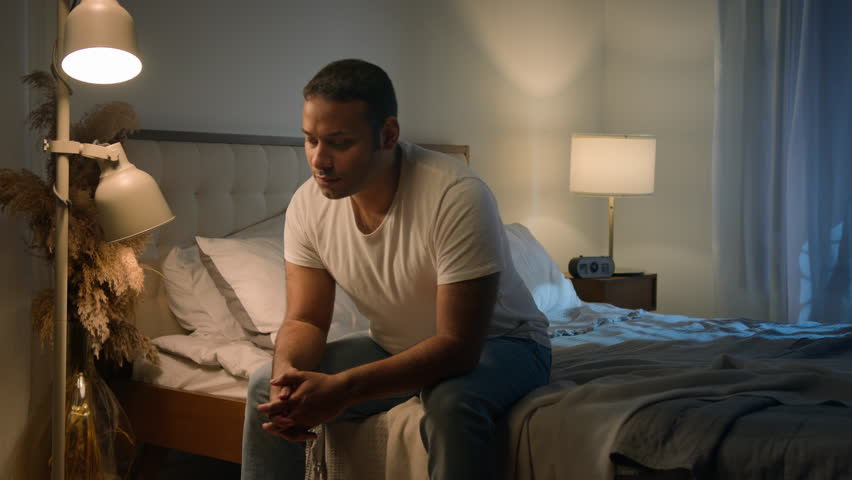 African American sad man sit on bed night evening at home suffer worried breakdown regret erectile dysfunction loving woman wife hug comforting support empathy crisis impotence potency health problem Royalty-Free Stock Footage #1110270541