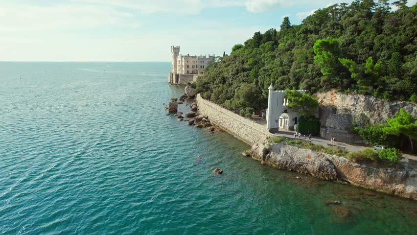 Beautiful aerial view of the Miramare Castle at the Adriatic sea coast in Italy. Drone revealing footage of the Miramare castle near Trieste, Italy. Italian summer holidays travel destination