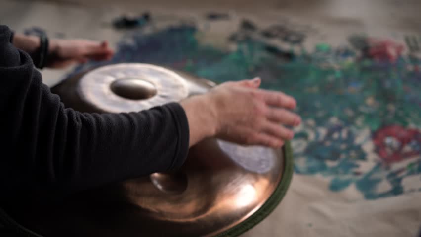Hands with hang drum close up, man practicing meditation music 