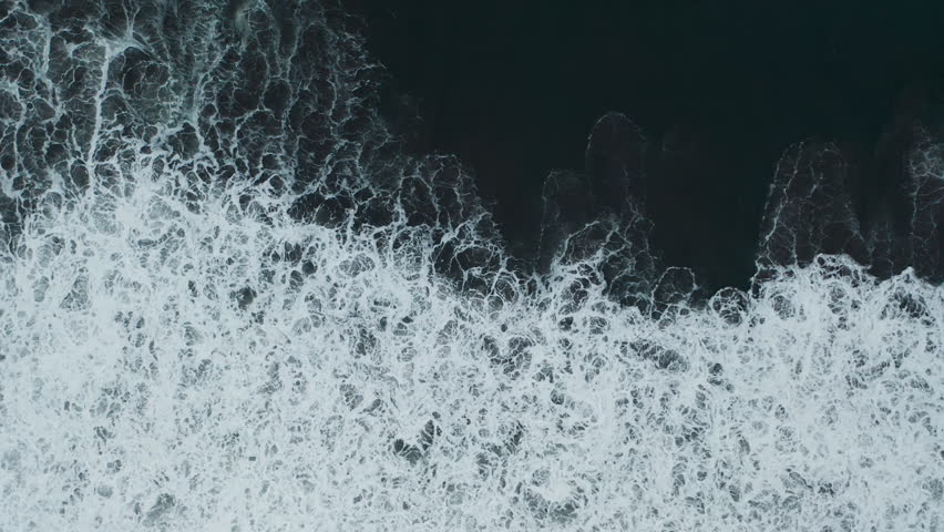 fascinating texture of big power dark ocean waves with white wash. Aerial top view footage of fabulous sea tide on a stormy day. Drone filming breaking surf with foam in pacific ocean. Slow motion Royalty-Free Stock Footage #1110277327