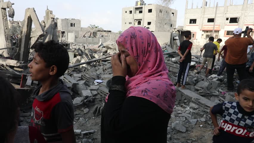 Palestinians inspect a house destroyed after an Israeli air strike in the city of Rafah, south of the Gaza Strip, on October 22, 2023.