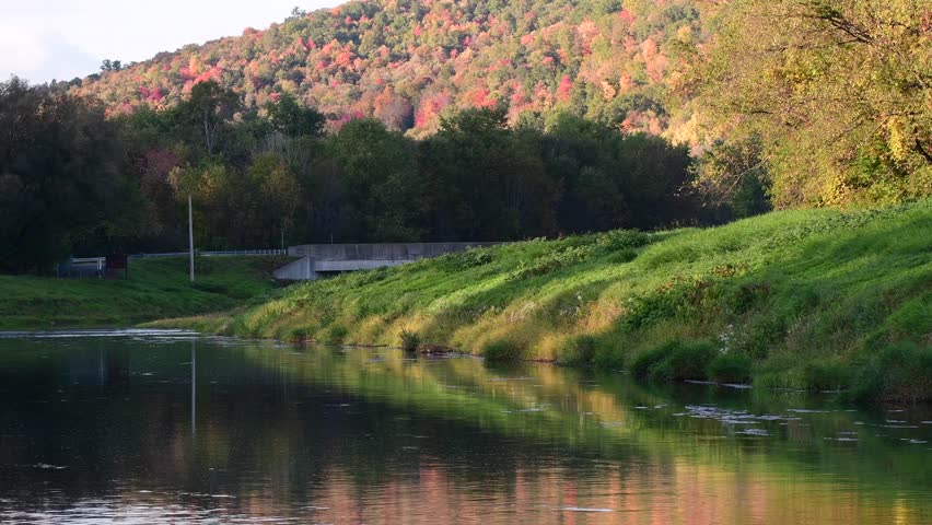 Perfect golden hour natural light over river valley park during autumn season.