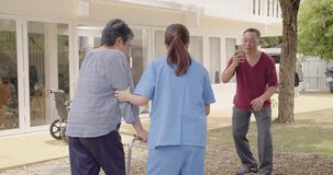 Asian Woman Nurse Supporting Caring Adult female Patient Outdoors during the Recovery of Leg Injuries and elderly husband shoots video his wife, Nurse Empowering Elderly Patients in their Recovery 
