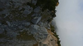 Vertical video. FPV maneuverable flight above the mountain range in Swiss Alps