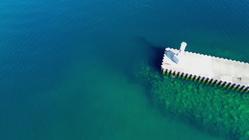 The Petoskey lighthouse is a smaller beacon style structure on Lake Michigan. Extreme high angle rotating shot of the lighthouse and it