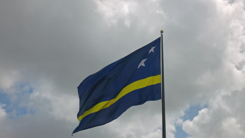 Close-up view of Curacao flag fluttering in wind against blue sky with fluffy white clouds. | Shutterstock HD Video #1110304875