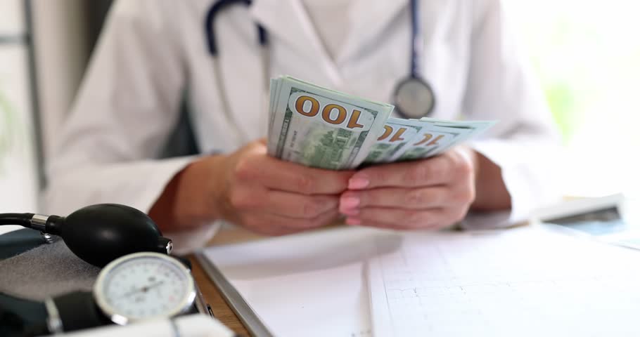 The doctor counts money at the table, close-up. Concept of expensive treatment, corruption in medicine Royalty-Free Stock Footage #1110307865