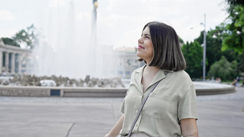 Young beautiful hispanic woman smiling confident standing at Vienna fountain