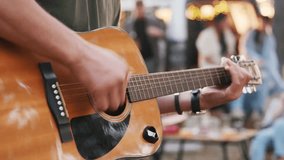 A group of friends on vacation in the forest on a warm summer evening. A picnic with a car and a fire. the guy plays the guitar - Powered by Shutterstock - Get 15% off with code: PIKWIZARD15