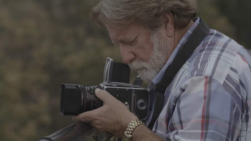 Close up of photographer holding retro film camera adjusting lens  the dalles, oregon, united states
