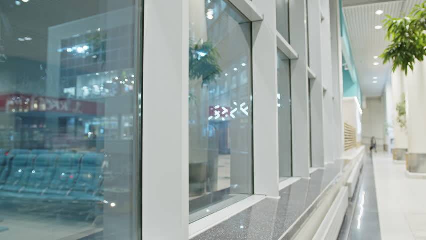 A young handsome man with a large hiking backpack in the airport terminal.