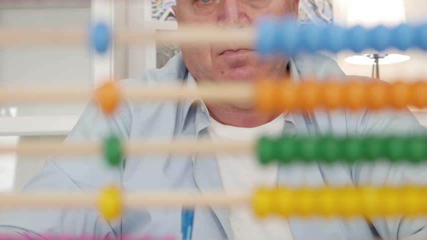 Upset and Disappointed Person Using a Balls Calculator. Counter with Colored Balls, a Tool Used for Learning to Calculate.