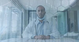 Animation of network of hexagons over biracial male doctor. Global medicine, finance, data processing and computing concept digitally generated video.