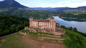 most famous and beautiful medieval castles of northern Italy. scenic Cles castel- in Trentino , province of Trento. lake Santa Giustina. Val di Non apple valley. aerial drone view