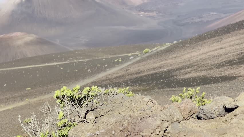 Cinematic booming up shot of the volcanic crater from the Sliding Sands trail at the summit of Haleakala on the island of Maui, Hawai