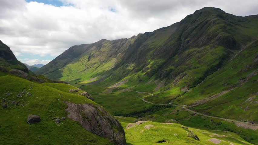 Glencoe, Scotland; Aerial shot along beautiful valley in the Scottish Highlands. Views of Scotland. Scottish Mountains, United Kingdom. Landscapes of Scotland.