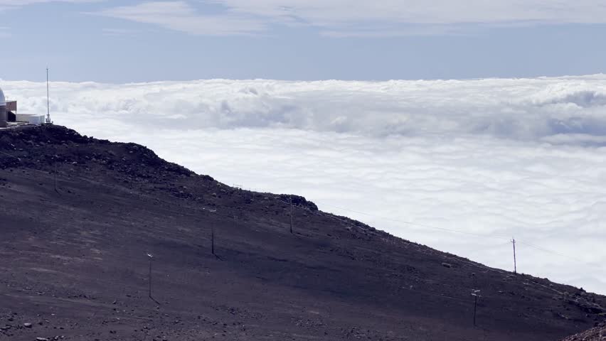 Cinematic panning shot of the Haleakala Observatory at the summit of Haleakala on the island of Maui in Hawai'i. 4K HDR at 30 FPS Royalty-Free Stock Footage #1110324451