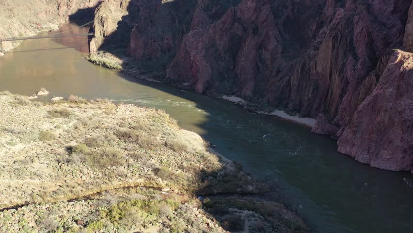 Colorado river aerial long pan along the banks inside the Grand Canyon