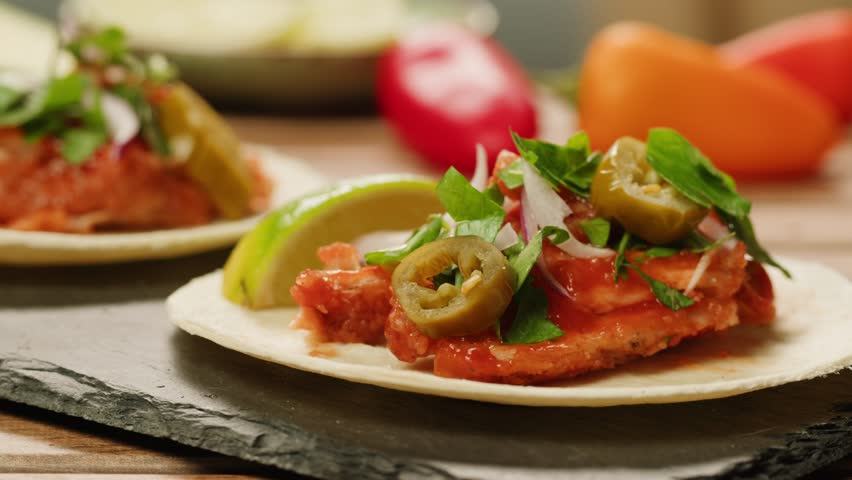 Traditional mexican food tacos with jalapeno pepper on the top close-up. Homemade tacos with meat and vegetables 