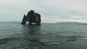 Hvítserkur is a magnificent three-legged creature-shaped sea mound in the north of Iceland. Stunning beach walk videos show the beauty of the environment, the strength and size of the rock. 