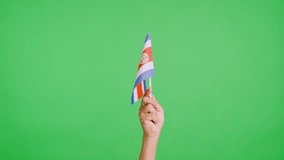 Hand waving a pennant of a costa rican national flag