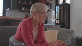 Video of an elderly woman at home sitting in front of a laptop computer having online consultations with her doctor about taking her medicine