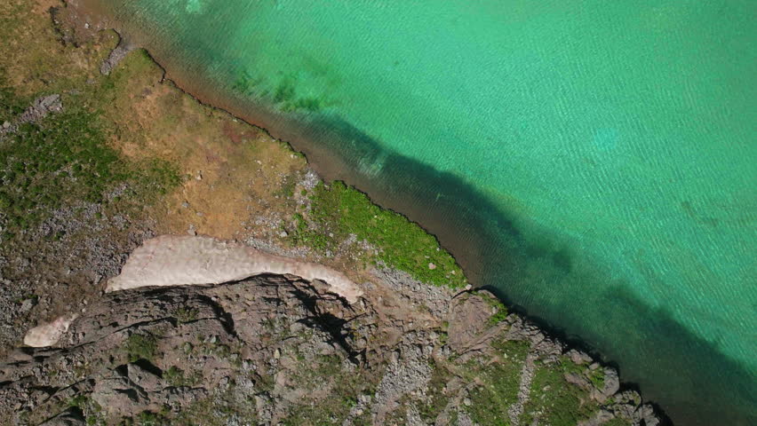 Epic looking down cinematic aerial drone high elevation dreamy heavenly Island Lake Silverton Ice Lake Basin unreal Caribbean aqua blue Silverton Colorado snow melt summer Rocky Mountains up motion