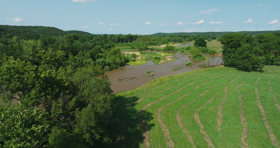 Illinois River Meandering Amid Greenery In Picturesque Landscape Of Arkansas In USA. aerial pullback
