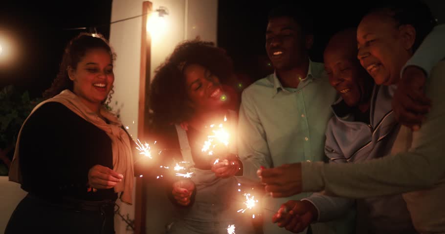 Happy african family celebrating new year's eve together at house terrace - Cinematic lights Royalty-Free Stock Footage #1110340719