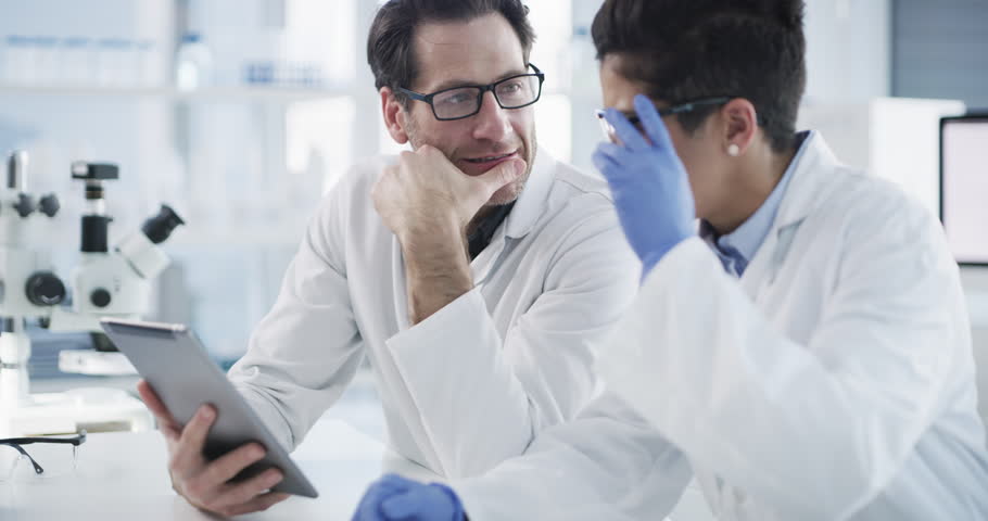 Teamwork, science and doctors with tablet in laboratory for medical research, talking and brainstorming. Collaboration, tech and scientists with digital touchscreen discussing experiment test data. Royalty-Free Stock Footage #1110340755