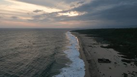 Drone flight above Bacocho Beach, powerful waves and sunset. Puerto Escondido, Oaxaca, Mexico
