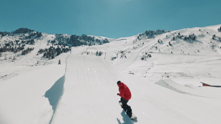 FPV drone shot of a snowboarder flying through the air
