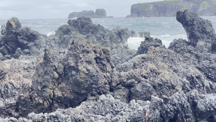 Cinematic booming up shot of rough waves crashing into lava rock along the Road to Hana in Maui, Hawai'i. 4K HDR at 30 FPS Royalty-Free Stock Footage #1110360273