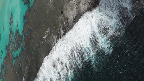 Waves washing over coral reef near Yejele Beach on Maré Island. Vertical aerial. - Powered by Shutterstock - Get 15% off with code: PIKWIZARD15