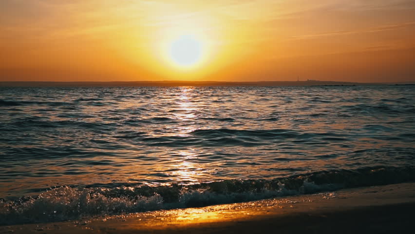 Sunset horizon over sea near water. View of beautiful evening sunset in sky over sea. Path of Sun is reflected on surface of sea. Nature. Beautiful cloudscape over river.