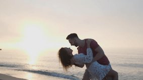 Beautiful couple dancing on beach at sunset, slow motion effect - Powered by Shutterstock - Get 15% off with code: PIKWIZARD15