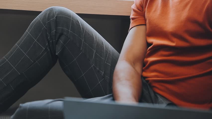 Young business man working at home with laptop and papers on desk