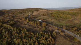 Aerial view drone image on the road truck drive trough the trees and forest in mountain range in autumn day  Tresibaba Knjazevac Mountain in Serbia