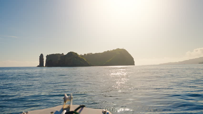 Boat speeding toward the island of Vila Franca do Campo in the Azores - Portugal. Slow Motion
Calm blue ocean, Clear sunny day. Royalty-Free Stock Footage #1110383643