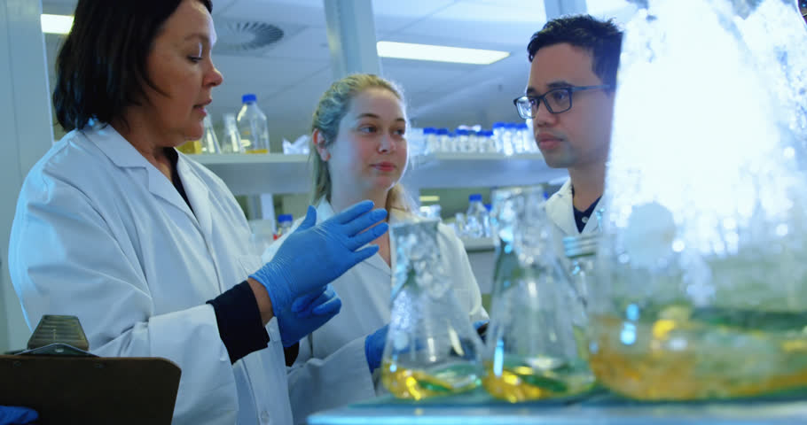 Animation of medical data processing over group of diverse scientists working at laboratory. Medical research and science technology concept